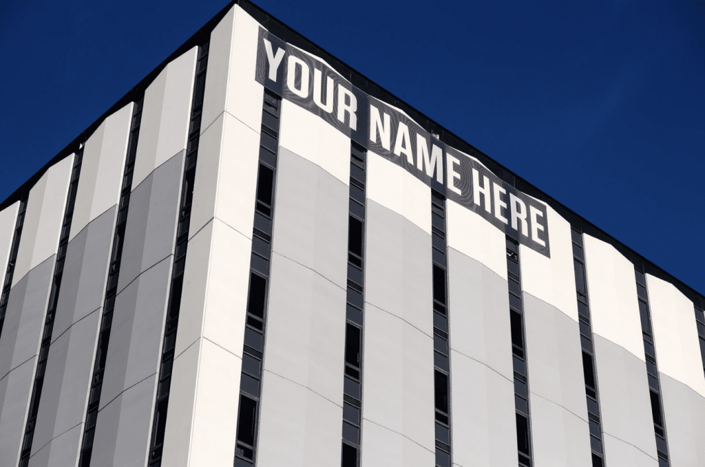 skylight building with 'your name here' on the side of the building