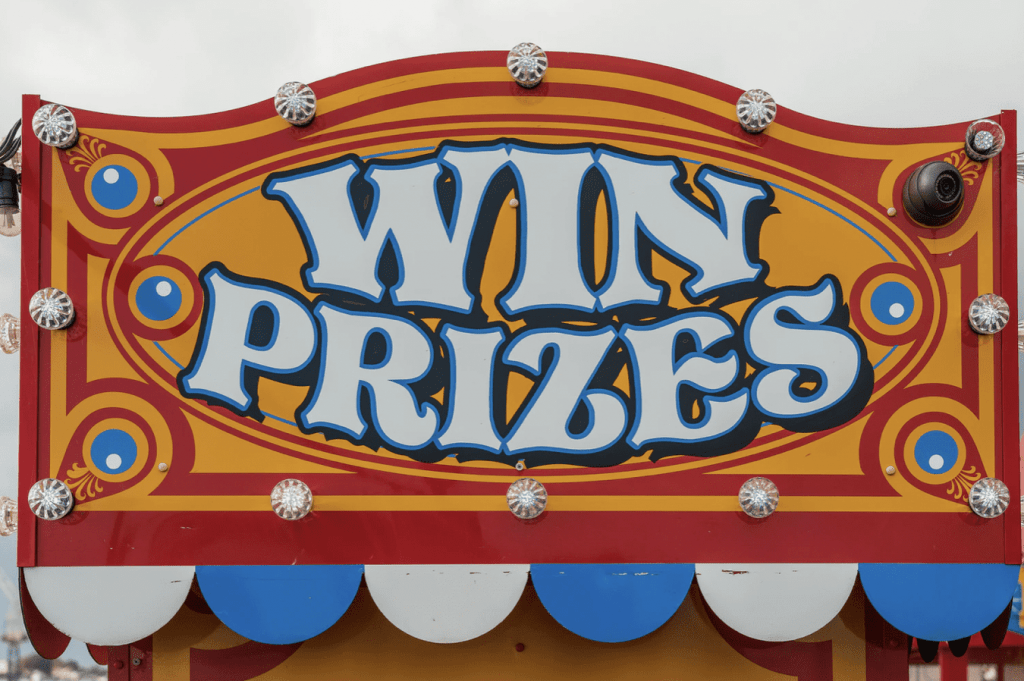 win prizes sign on the side of a fairground stall 