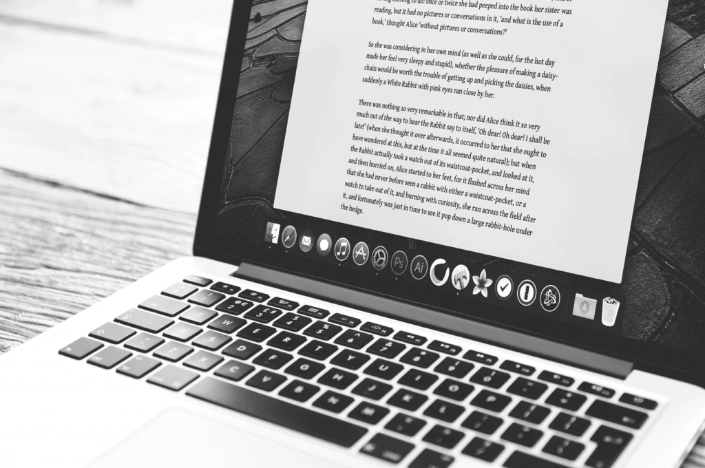 Writing a brief on a laptop, black and white image