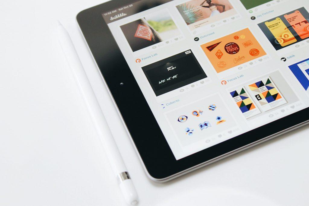 iPad with graphic designs displayed on homepage