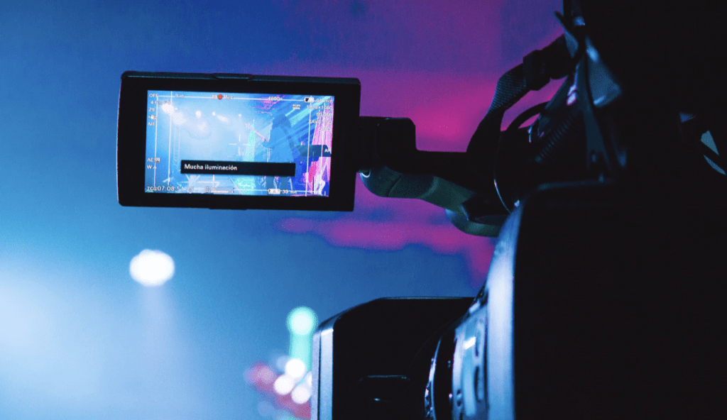 video camera filming a pink and blue nightclub scene