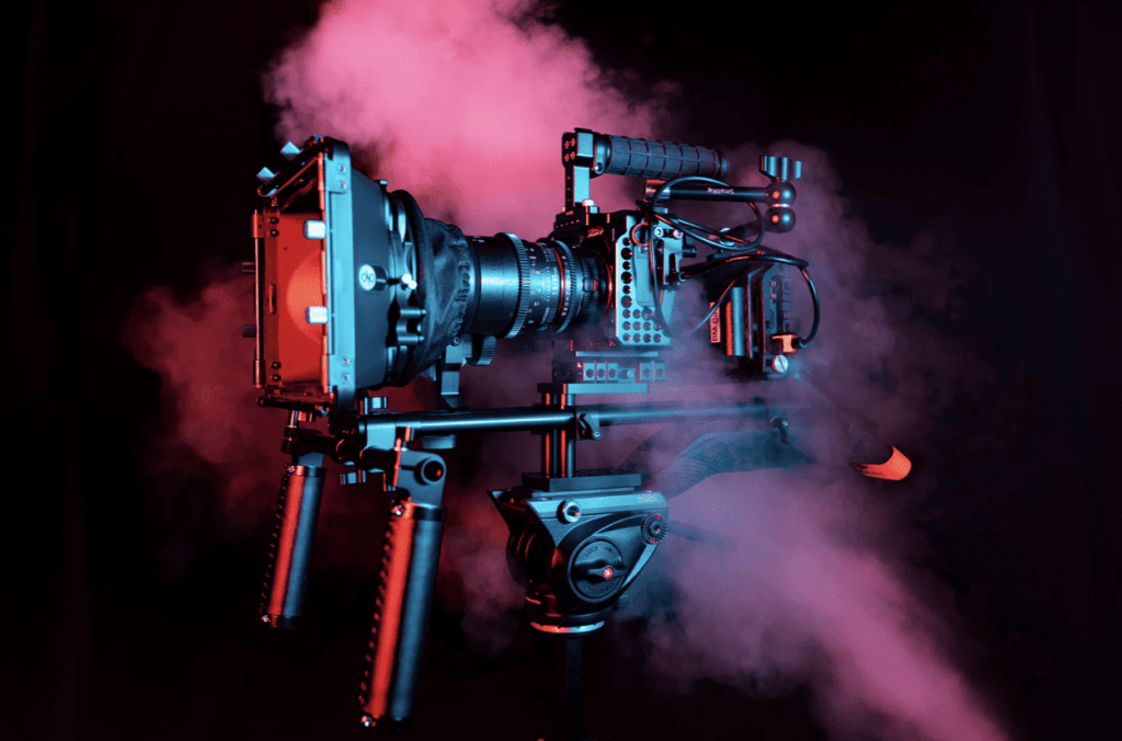 video camera with pink smoke on black background