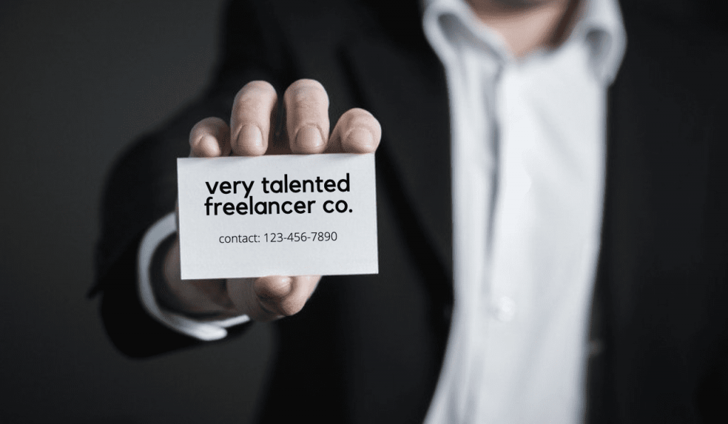 freelancer holding out a business card