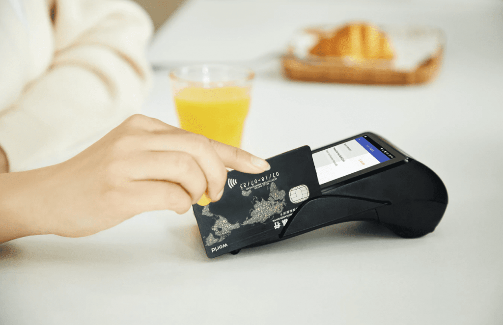 woman swiping credit card in card machine