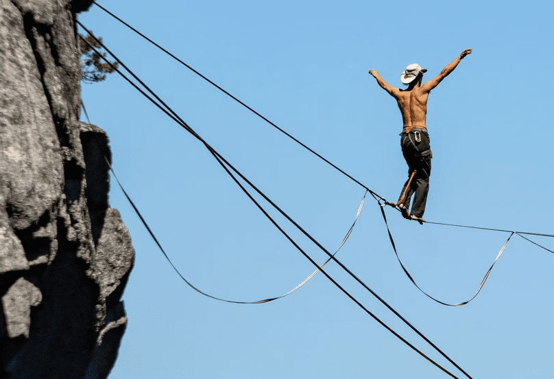 man walking on tightrope