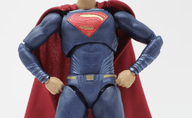 action figure wearing superman cape imitating a freelance copywriter