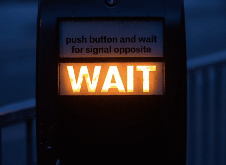 wait sign to symbolise not making overly optimistic statements in business plan