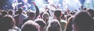 Photo of a crowd at a gig. The right crowdfunding graphics help you meet your crowdfunding goal.