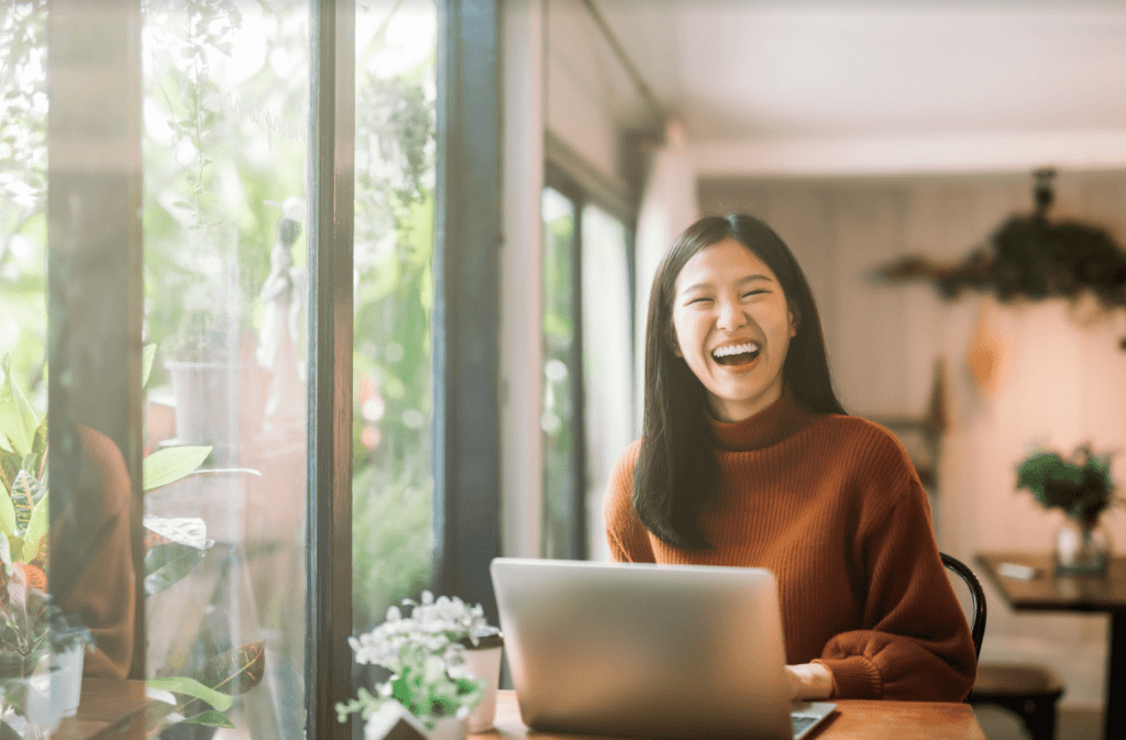 woman working at laptop and smiling