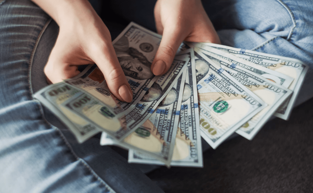 freelancer holding pile of money